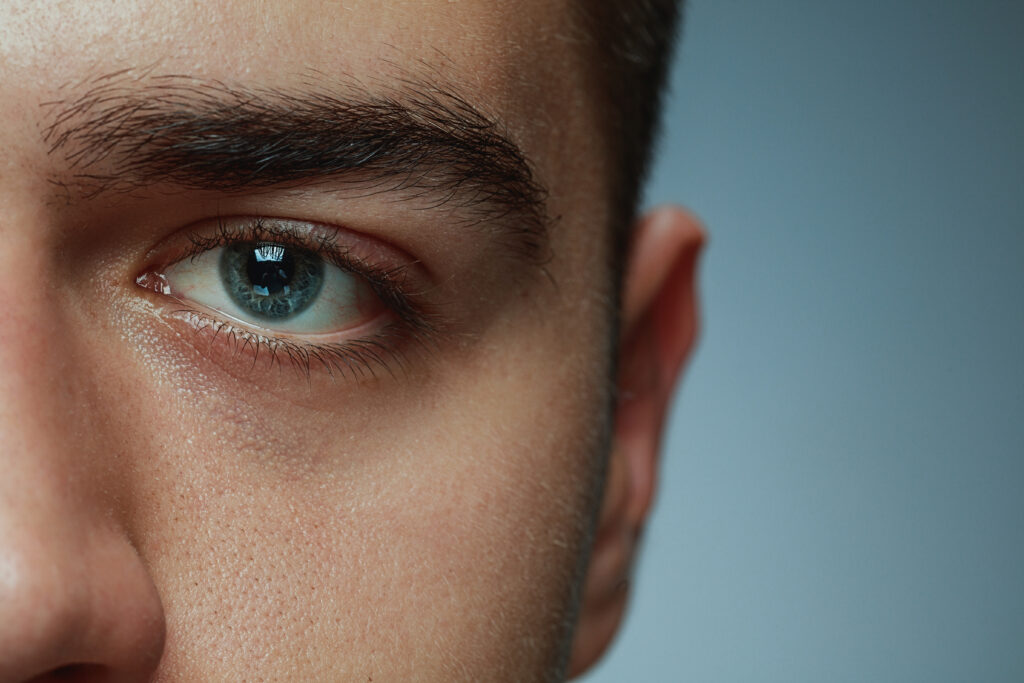 close up portrait young man isolated grey studio background caucasian male model s face blue eye concept men s health beauty self care body skin care medicine phycology, eye twitching